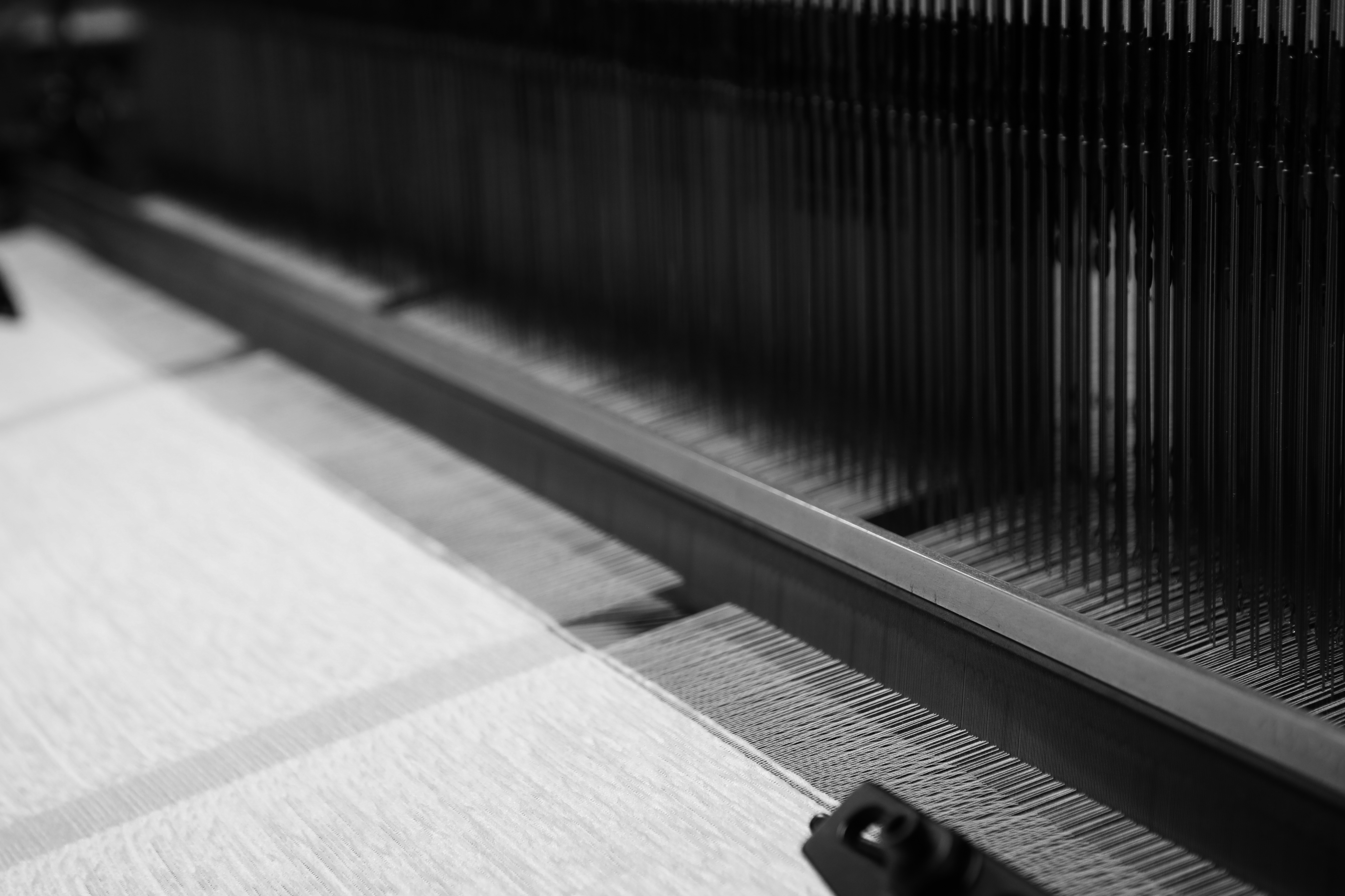 An industrial loom weaving a seamless garment directly from yarn